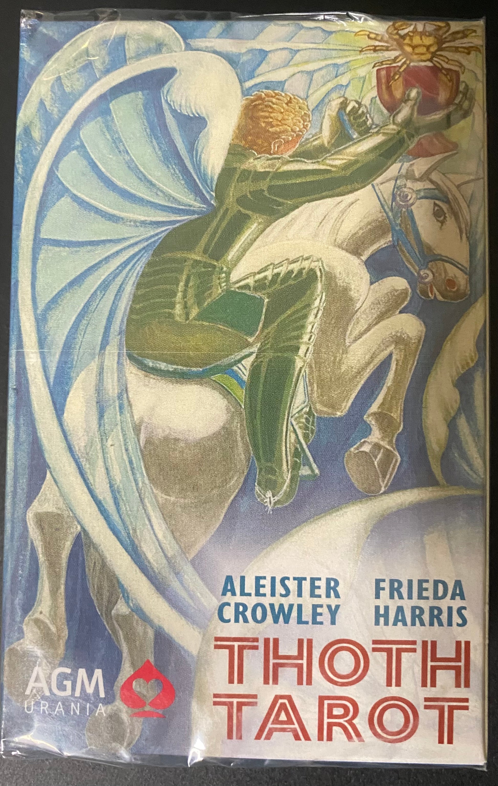 Cover of Thoth Tarot with artwork of a winged figure on a horse, featuring Aleister Crowley and Frieda Harris.