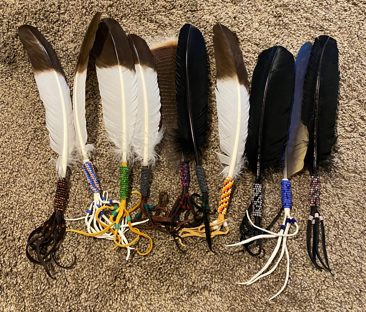 Feathers with decorative elements on a textured surface