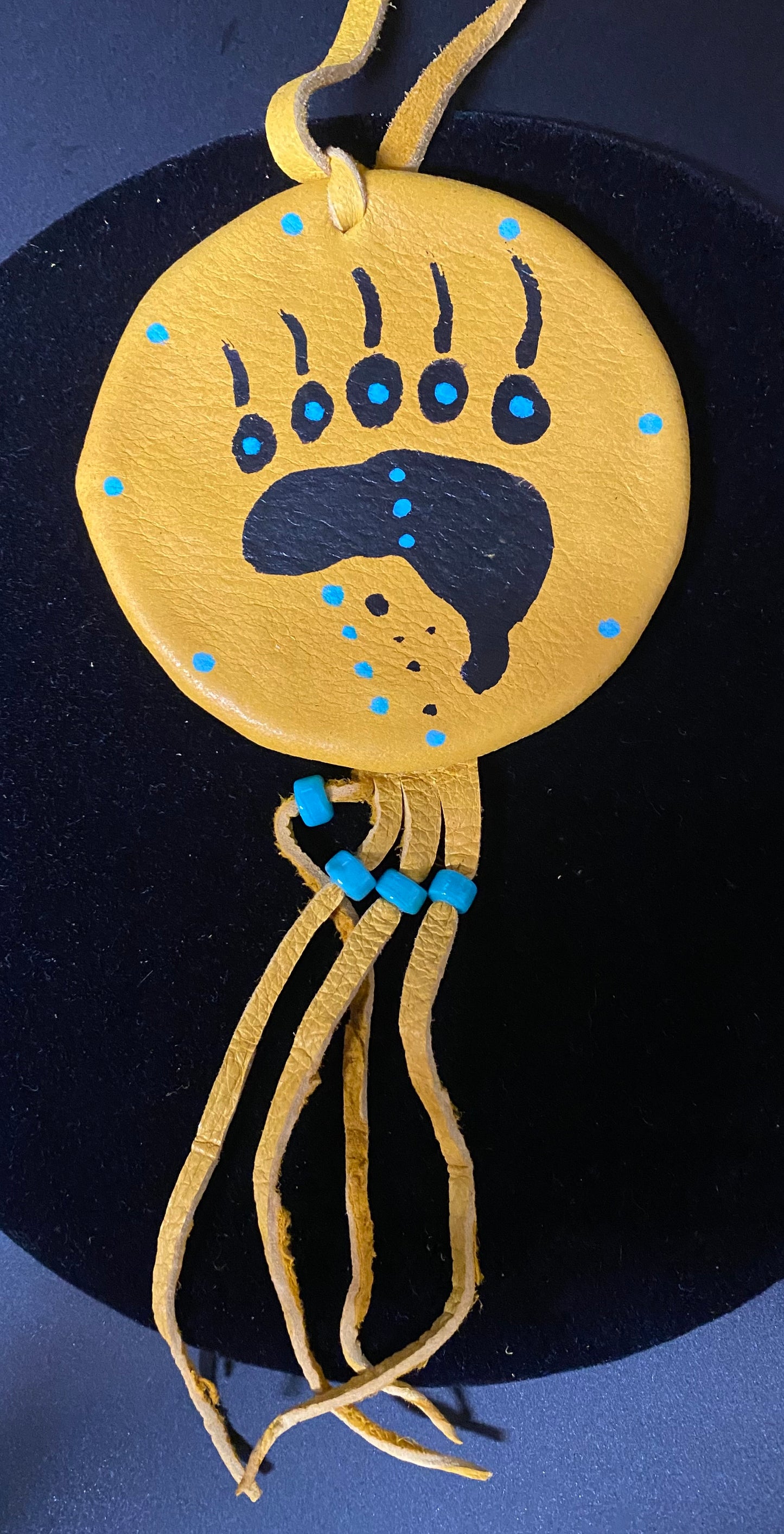 Decorative item with a bear paw design on a blue background