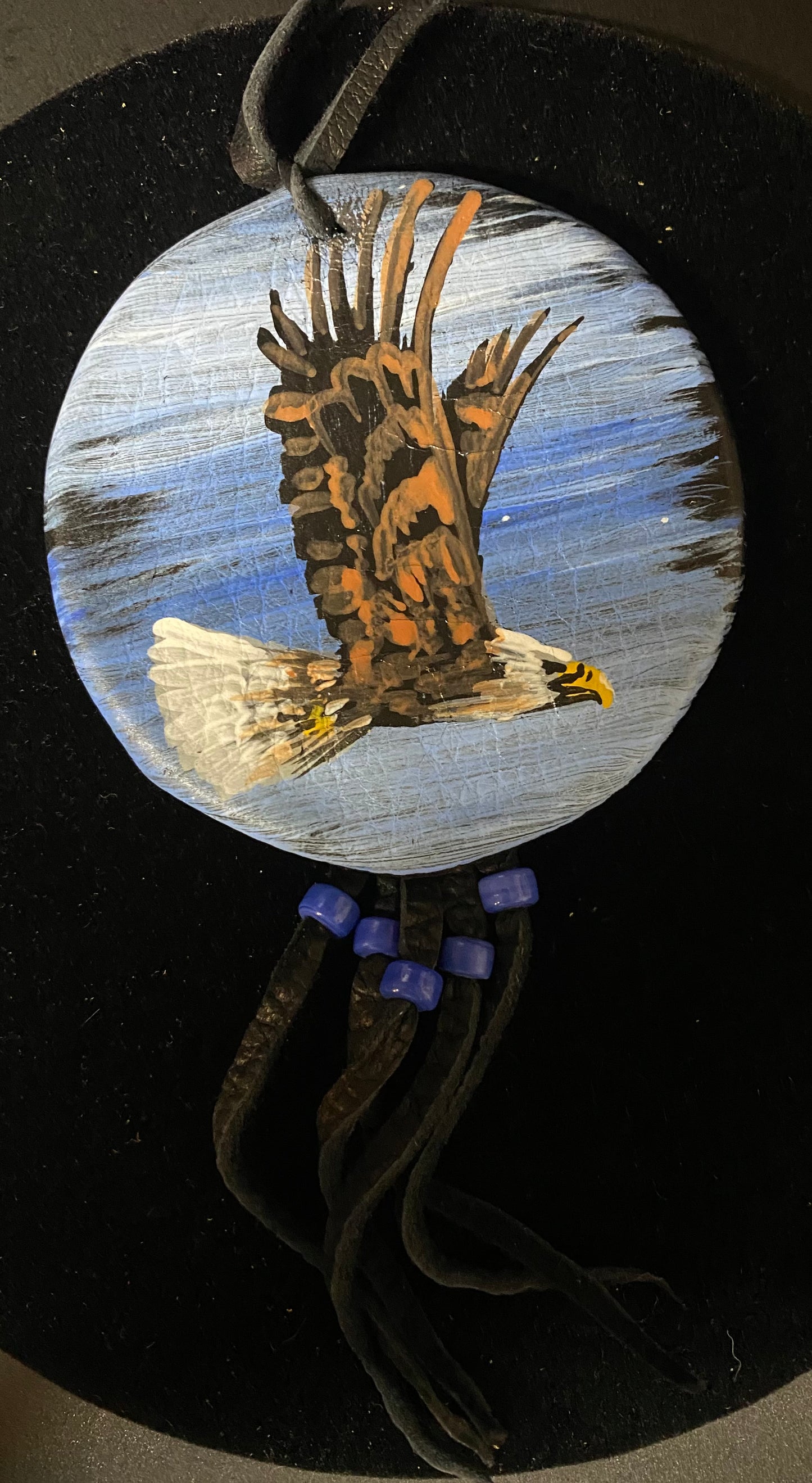 Decorative item with an eagle design on a circular background