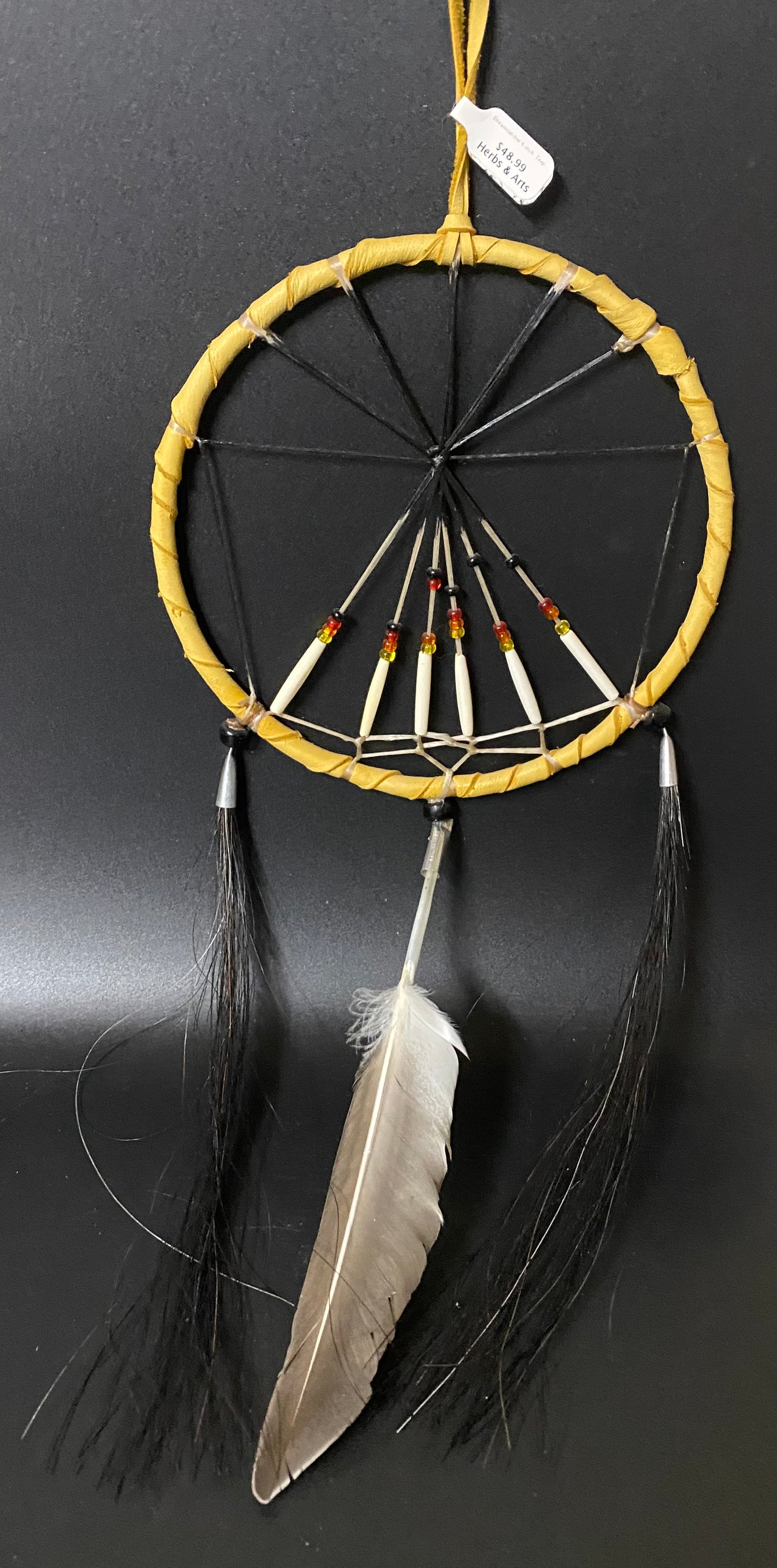 Dreamcatcher with feathers on a black background