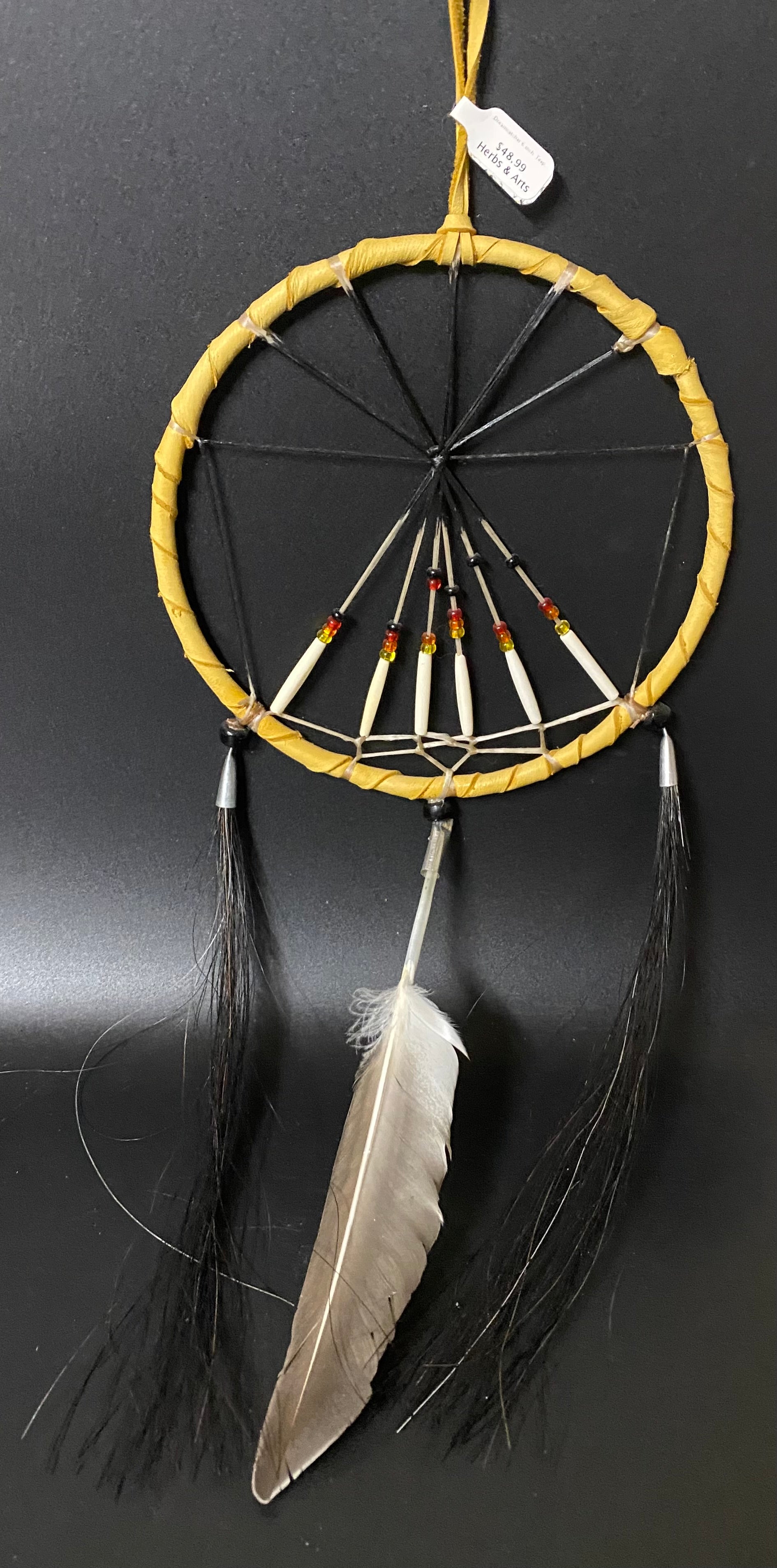 Dreamcatcher with feathers on a black background