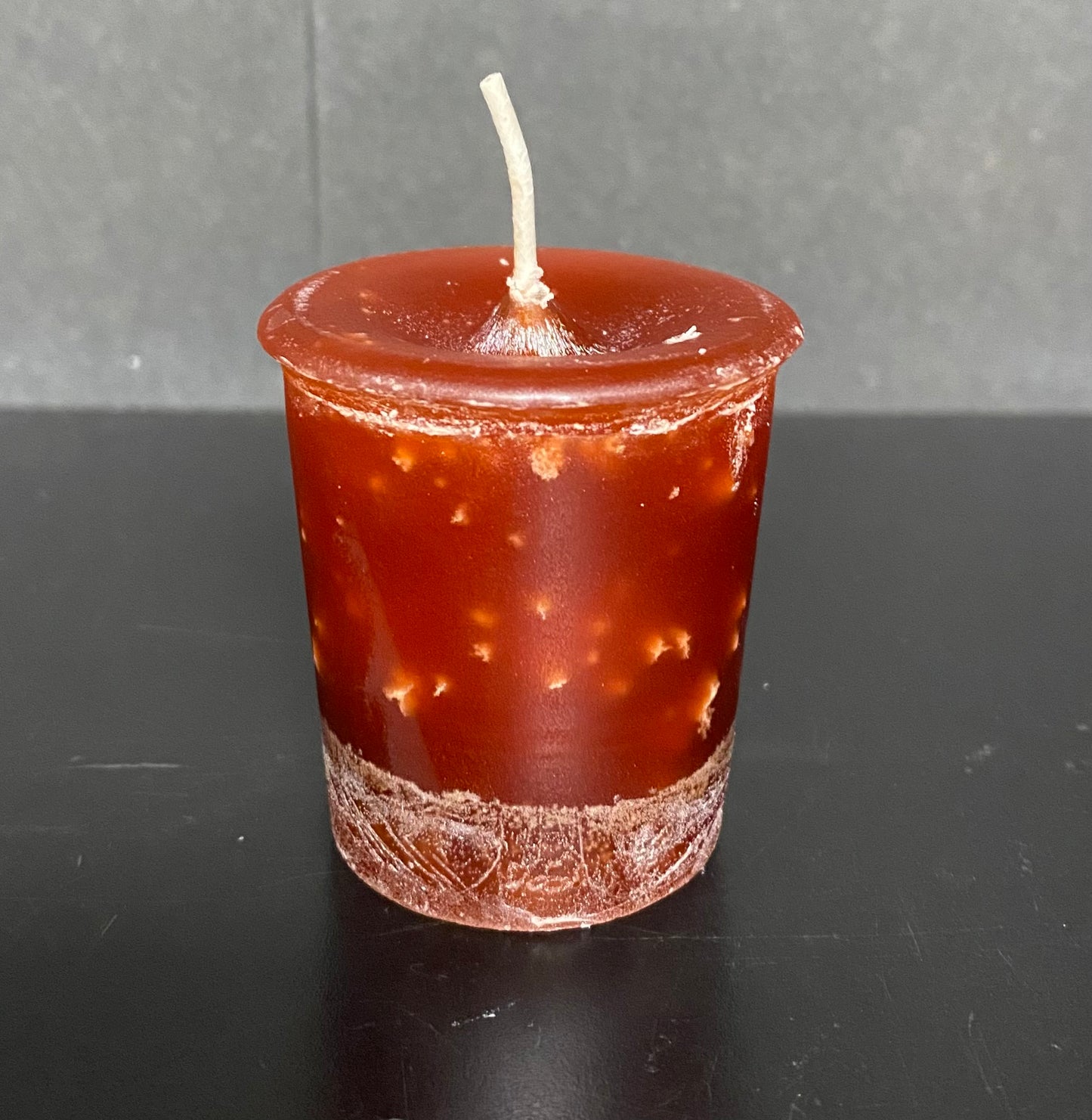 Brown candle with a gray background