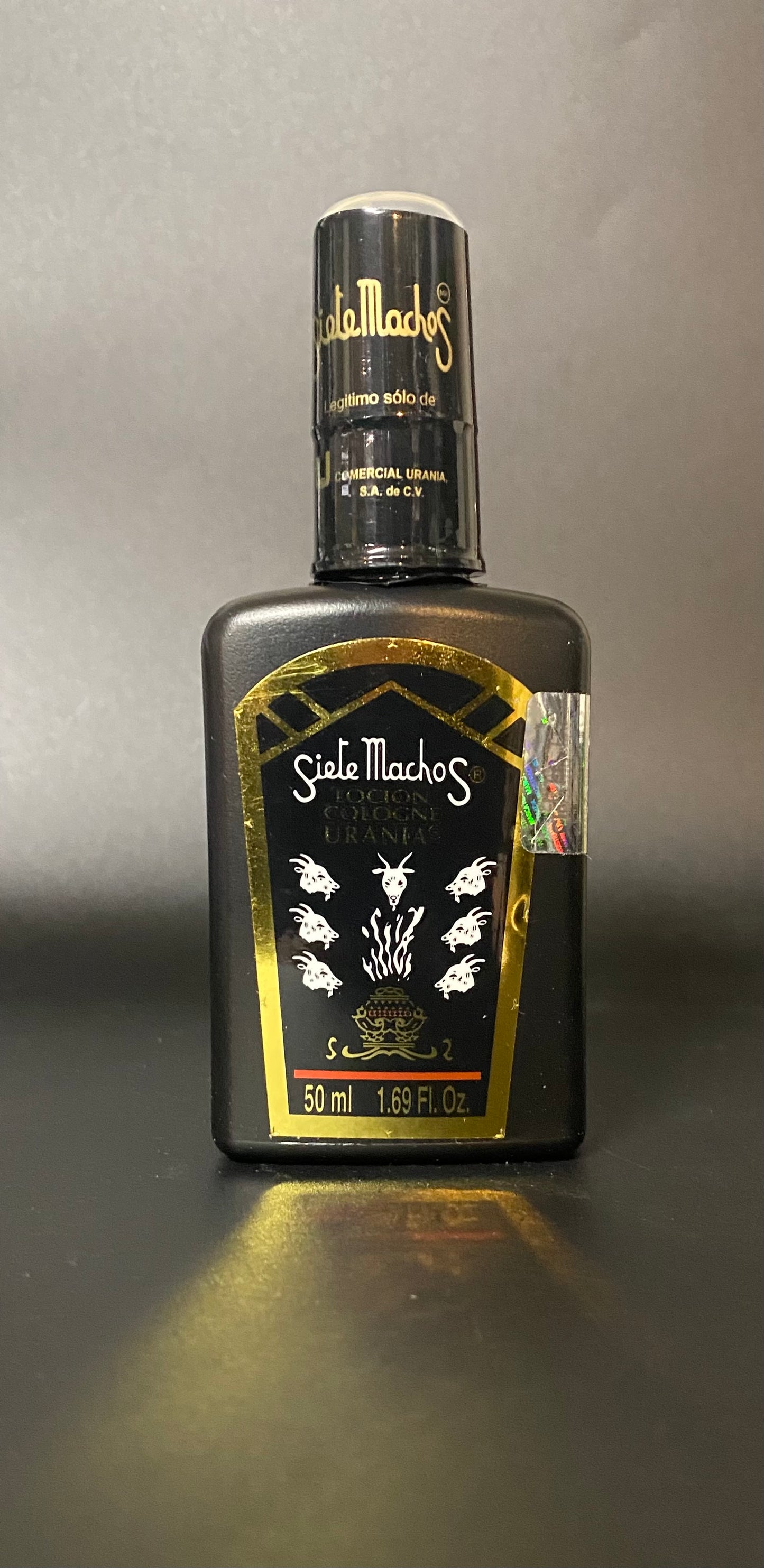 Bottle of Siete Machos on a gray background