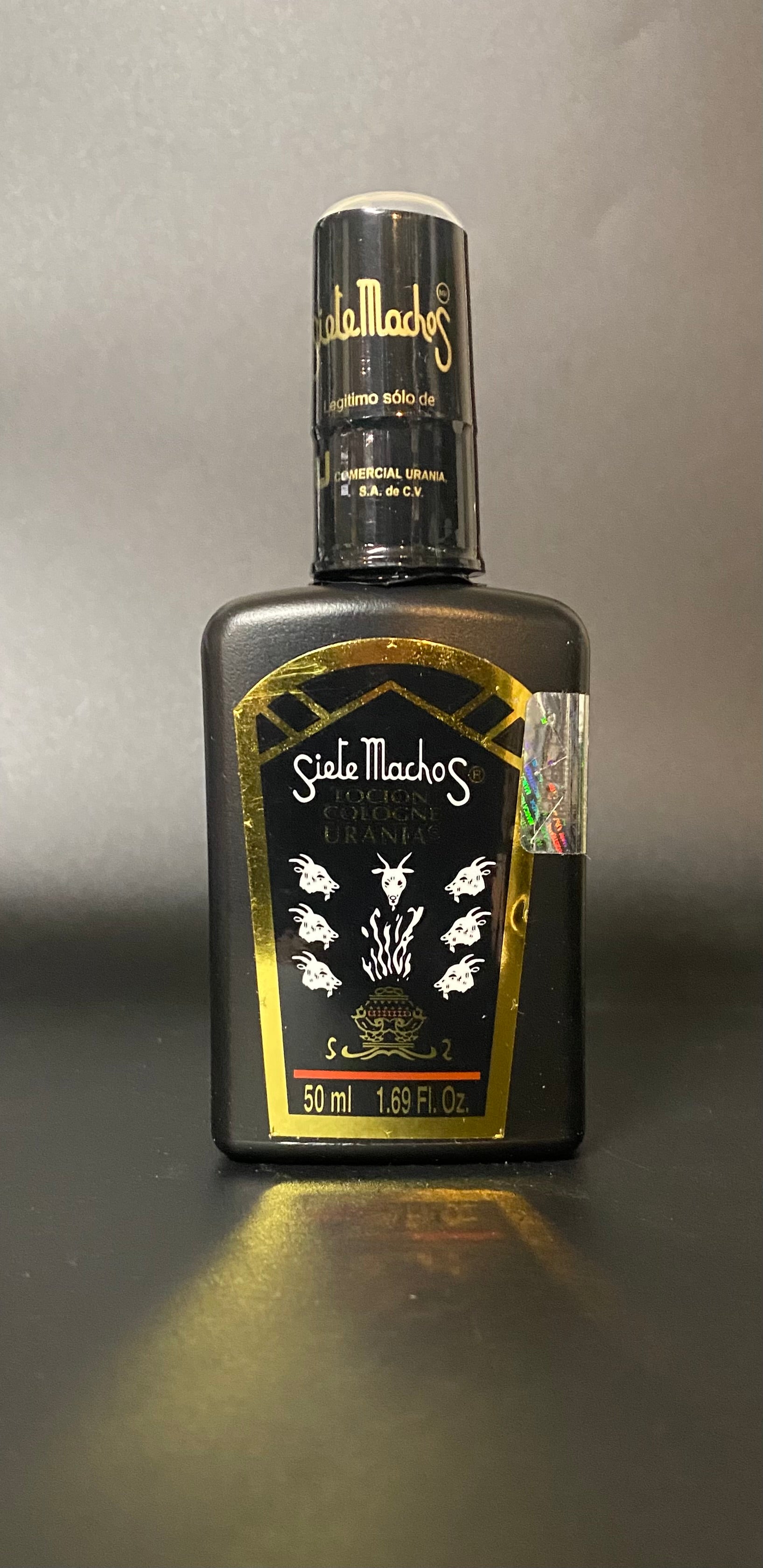 Bottle of Siete Machos on a gray background