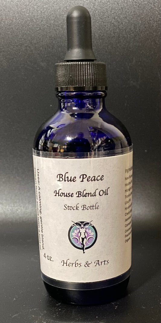 Bottle of Blue Peace House Blend Oil with a dropper on a dark background