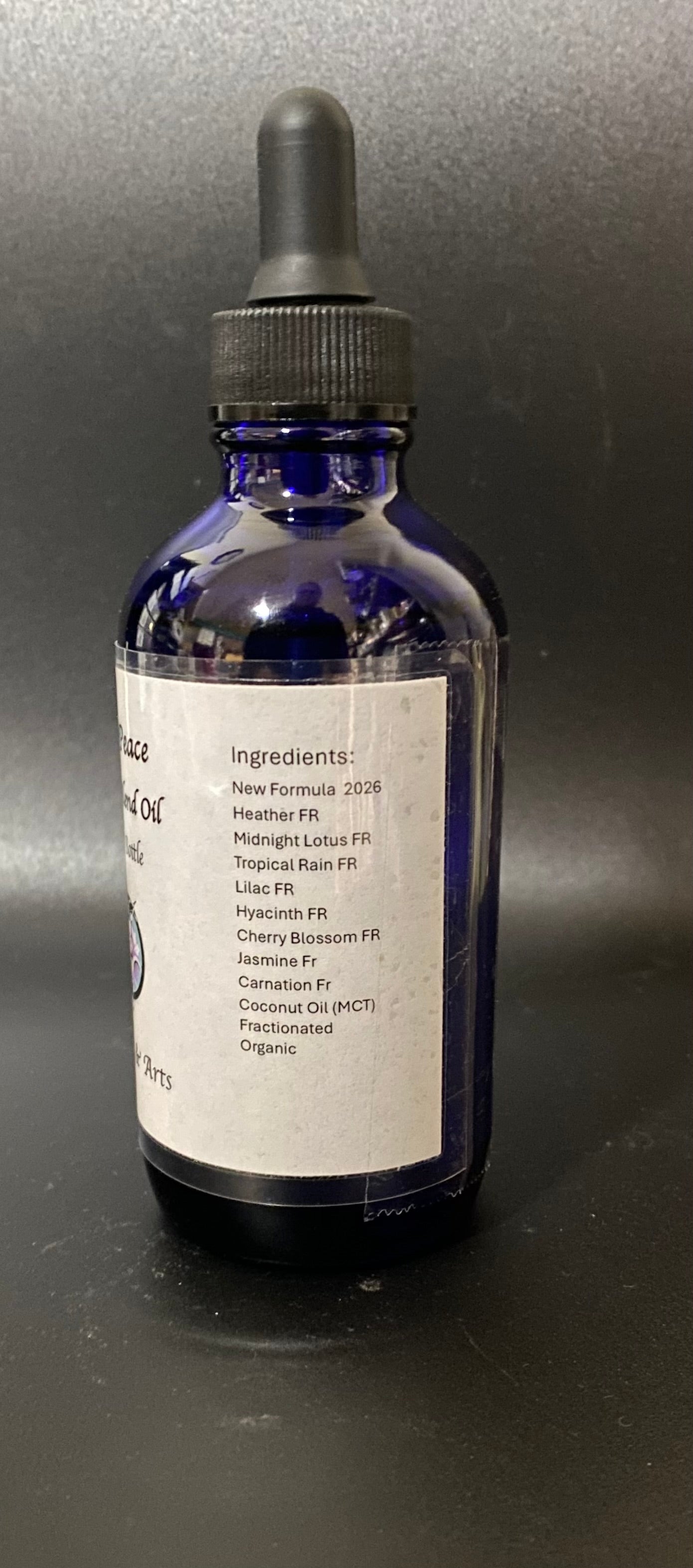 Bottle of liquid with a dropper on a dark background