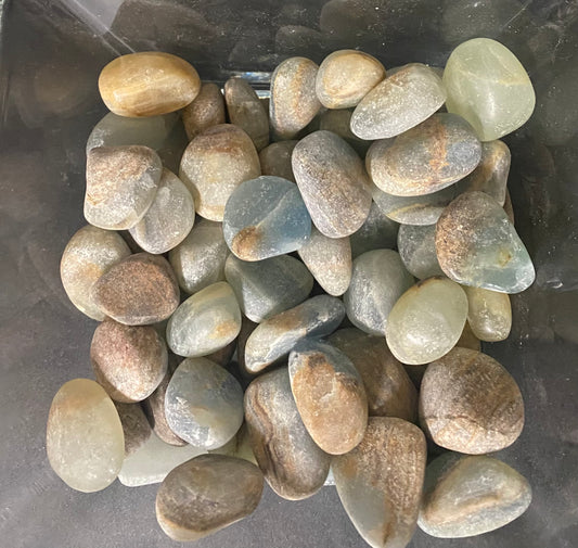 Assorted colored stones on a dark background