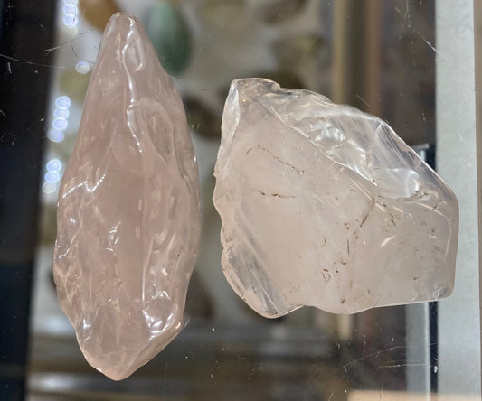 Two crystal-like objects on a reflective surface