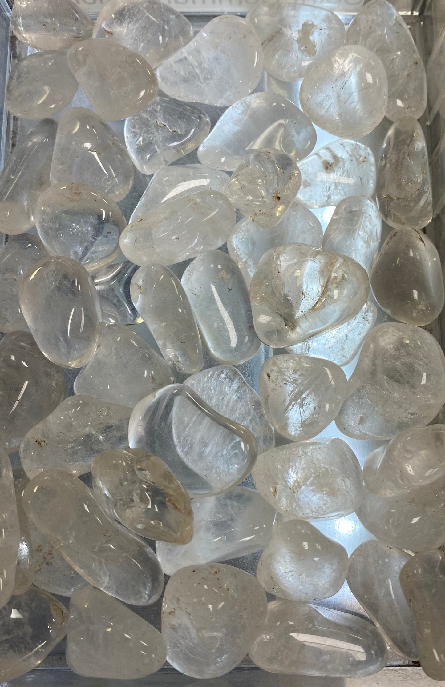 Clear glass stones on a reflective surface