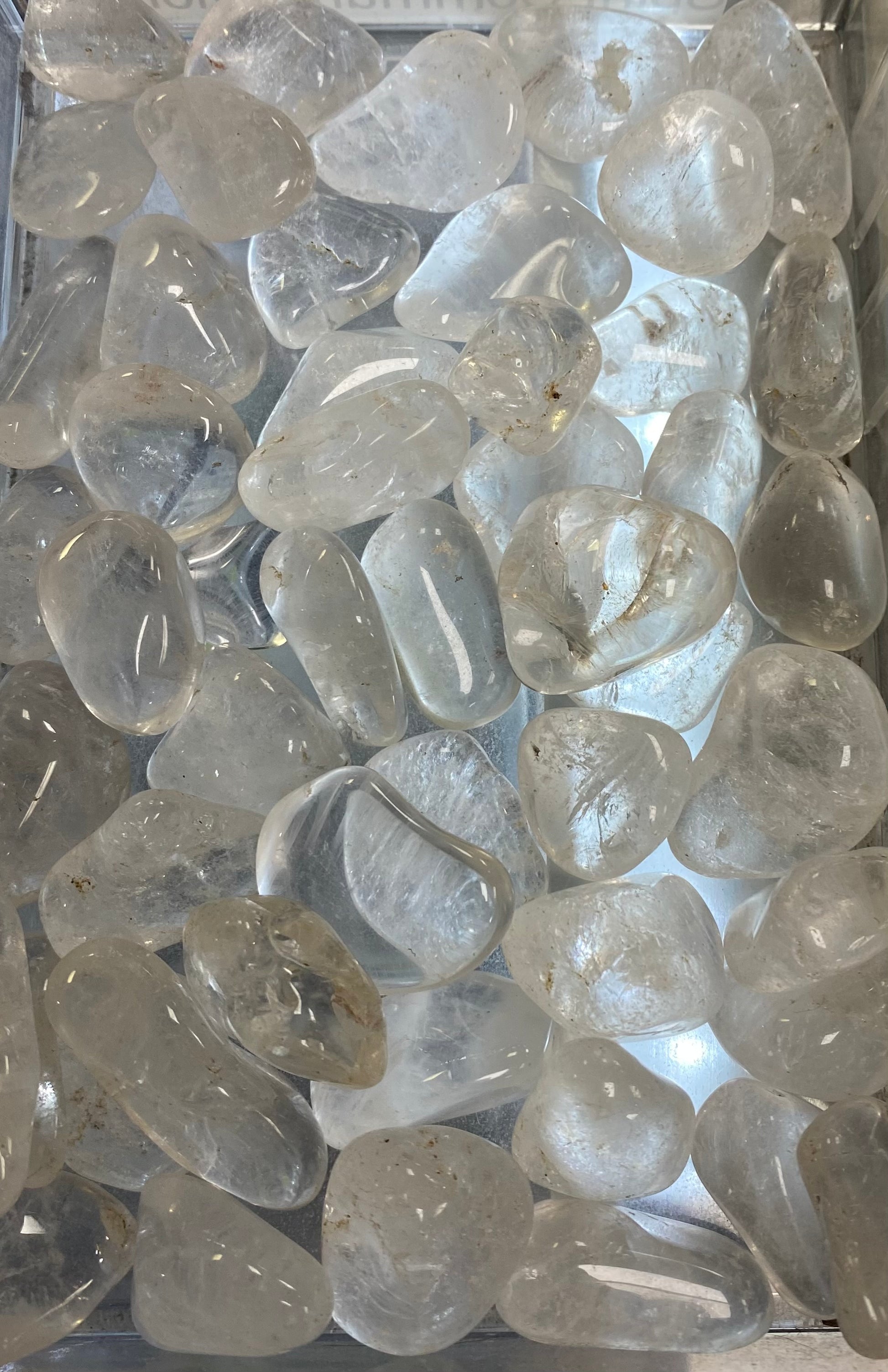 Clear glass stones on a reflective surface
