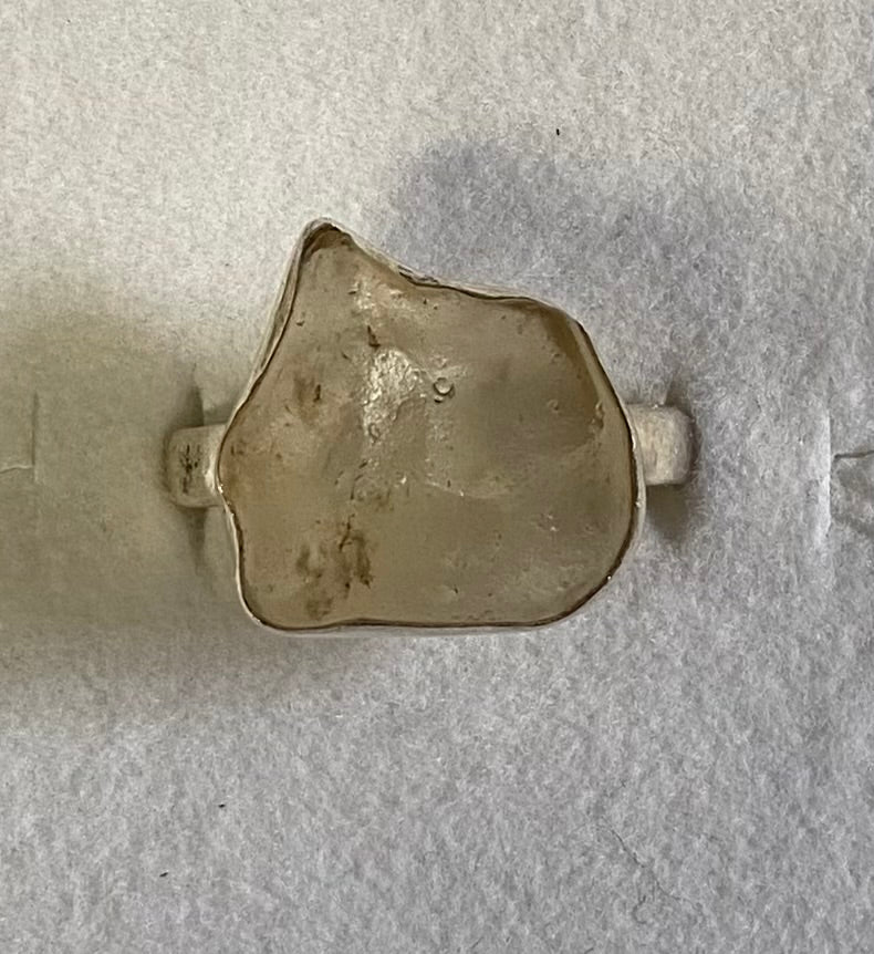 Small metallic object on a textured gray surface