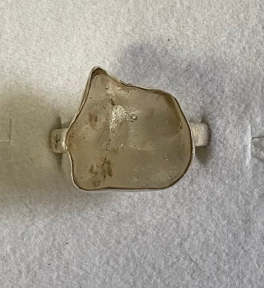 Small metallic object on a textured gray surface