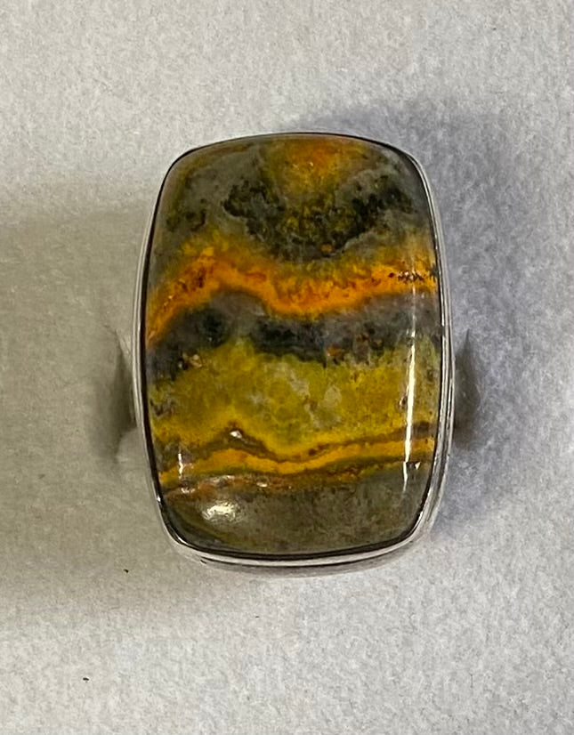 Ring with a colorful stone on a gray background