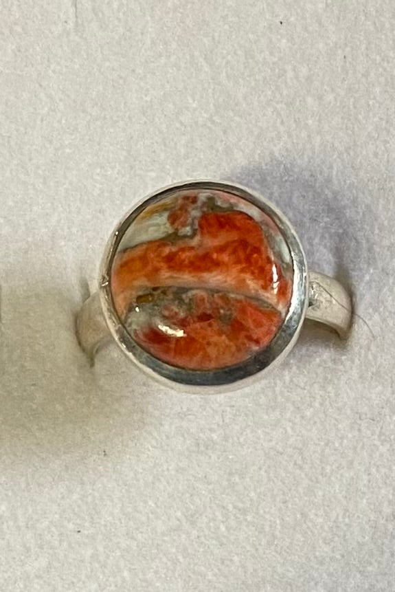 Ring with a red stone on a white background