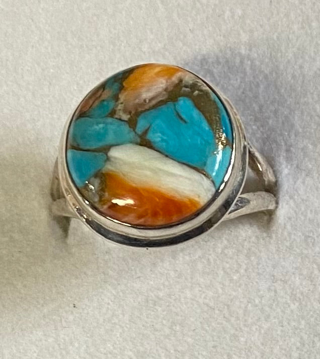 Ring with a colorful stone inlay on a white background