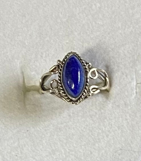Silver ring with a blue stone on a white background