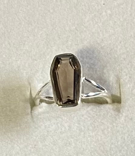 Silver ring with a smoky quartz stone on a white background