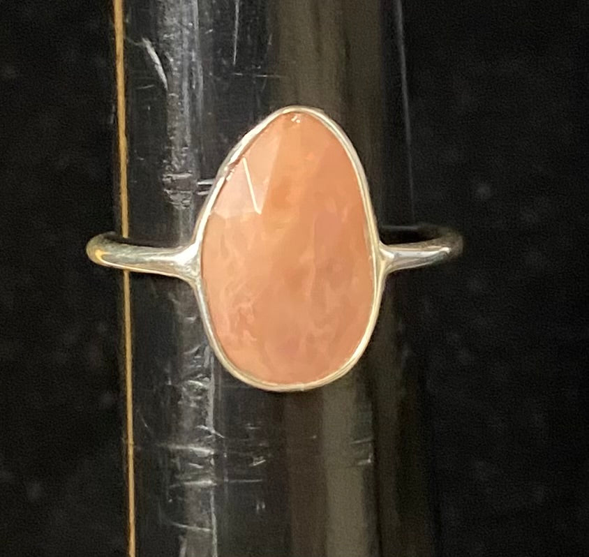 Ring with a pink stone on a black background