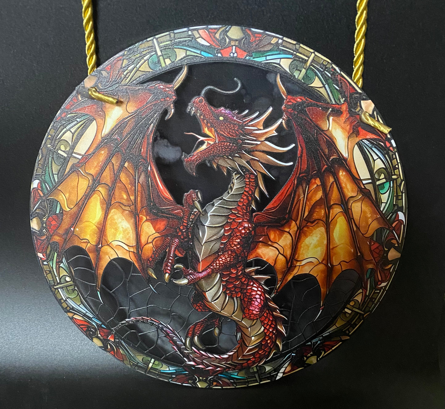 Decorative sun catcher with a dragon design on a black background