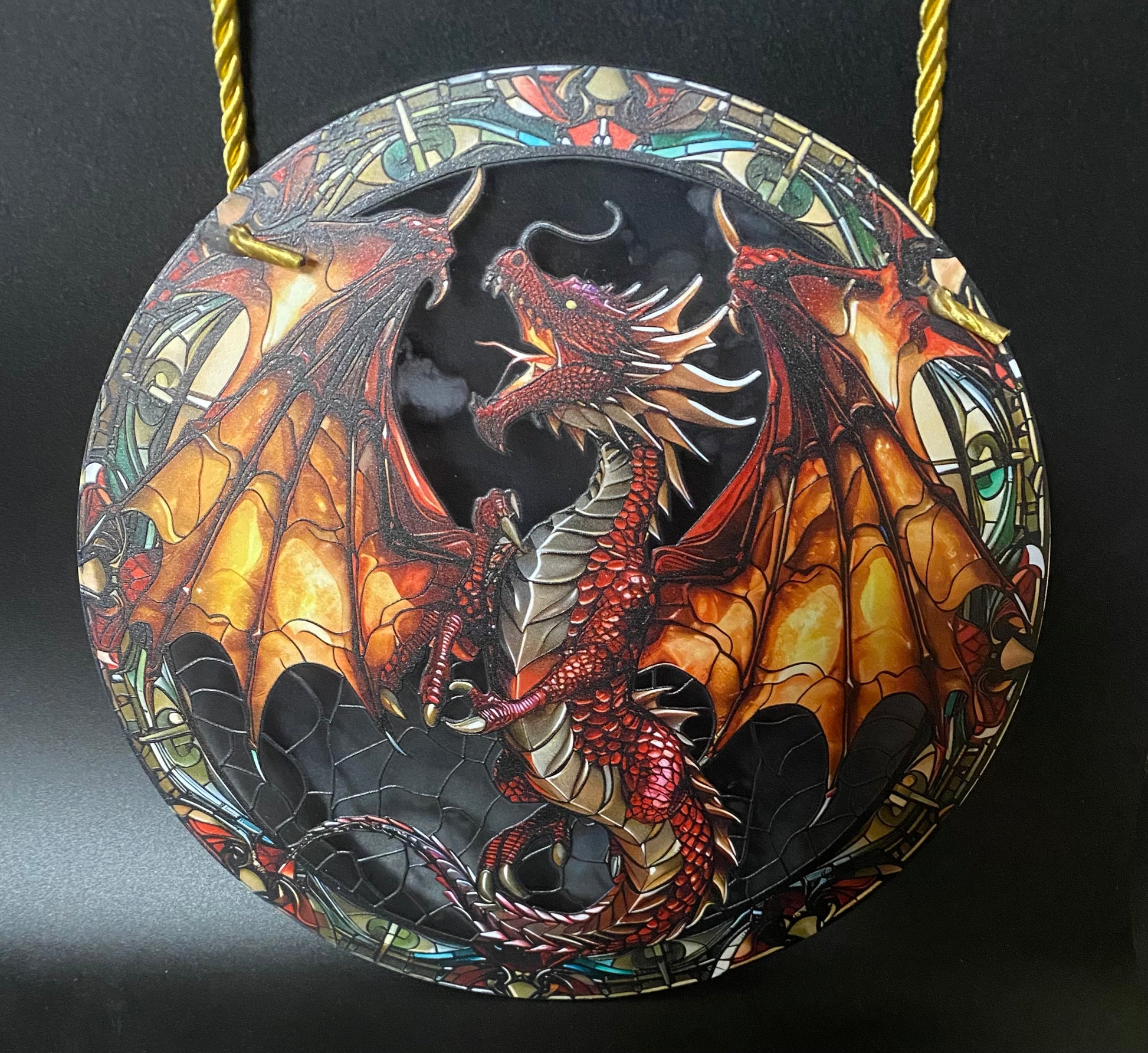 Decorative sun catcher with a dragon design on a black background