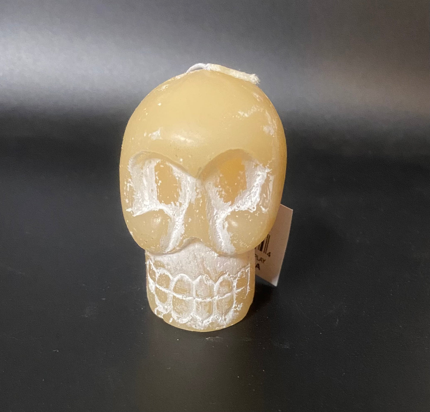 Skull-shaped candle on a dark background