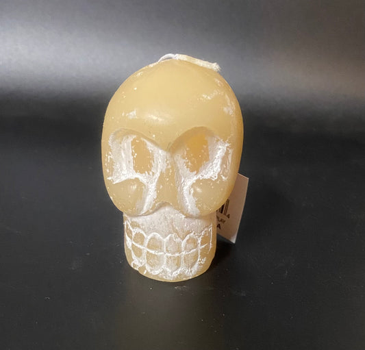 Skull-shaped candle on a dark background