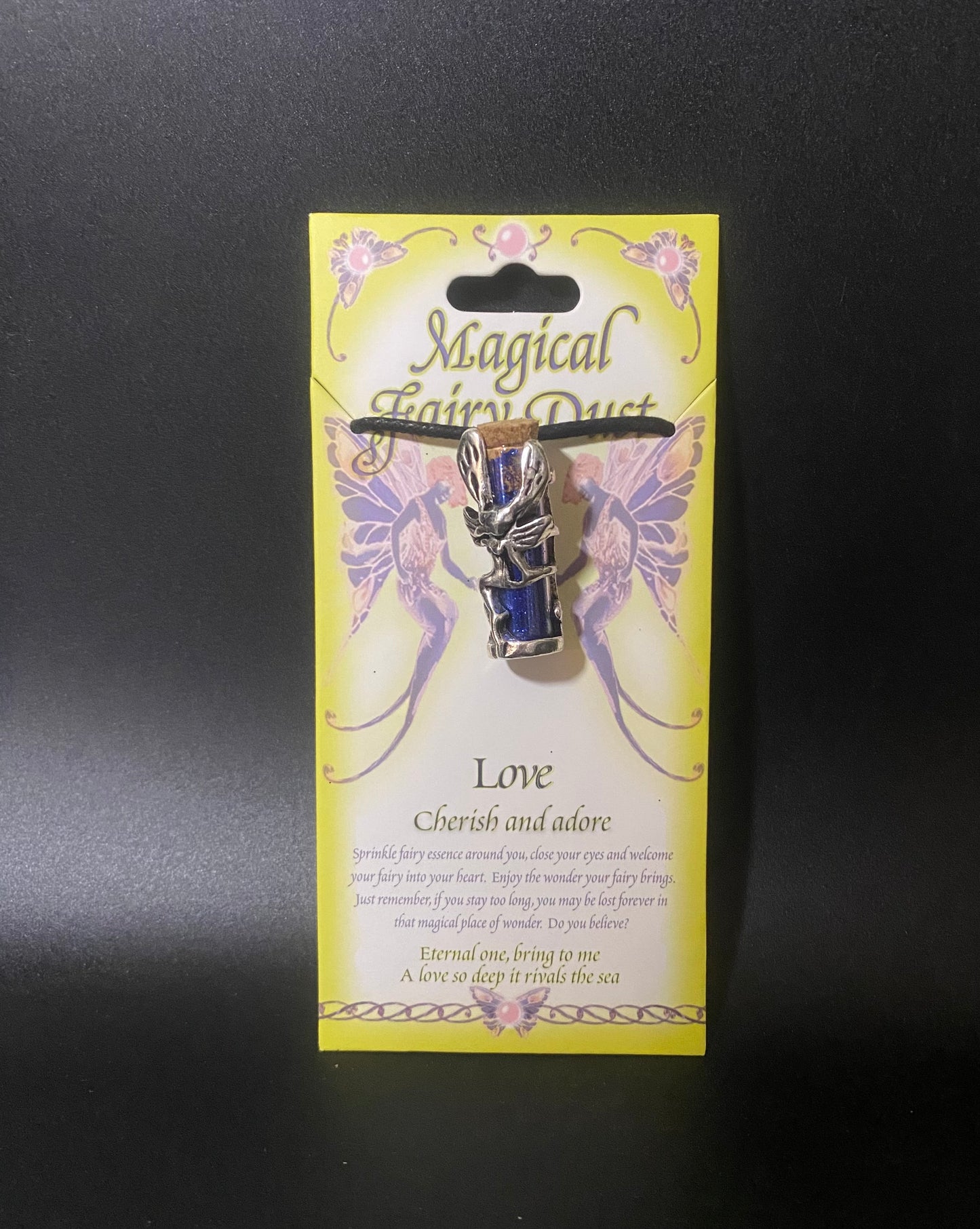 Fairy dust pin on a yellow card with decorative text and fairy designs.