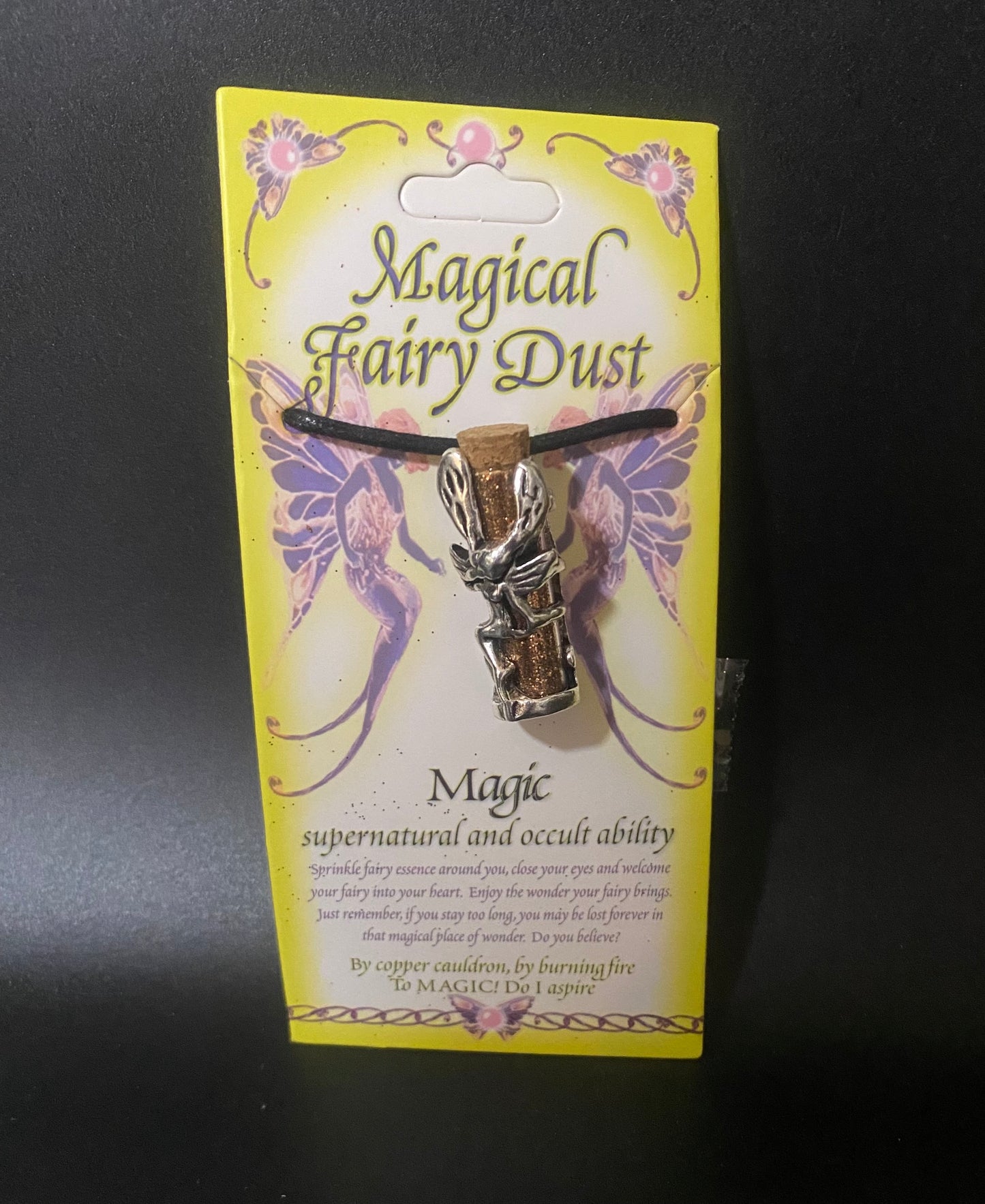 Magical Fairy Dust necklace packaging with fairy design on a dark background