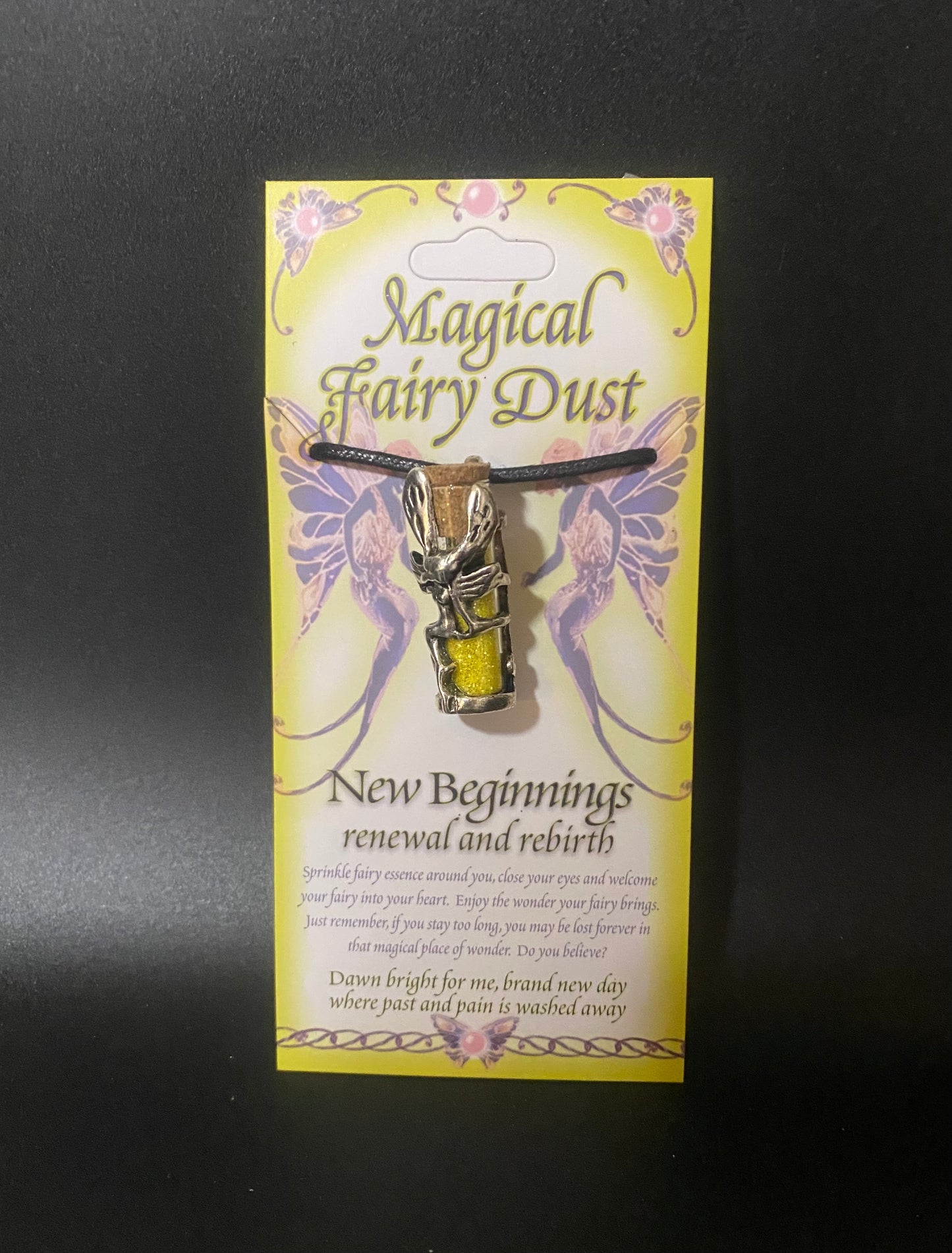 Fairy dust necklace on a yellow card with fairy designs