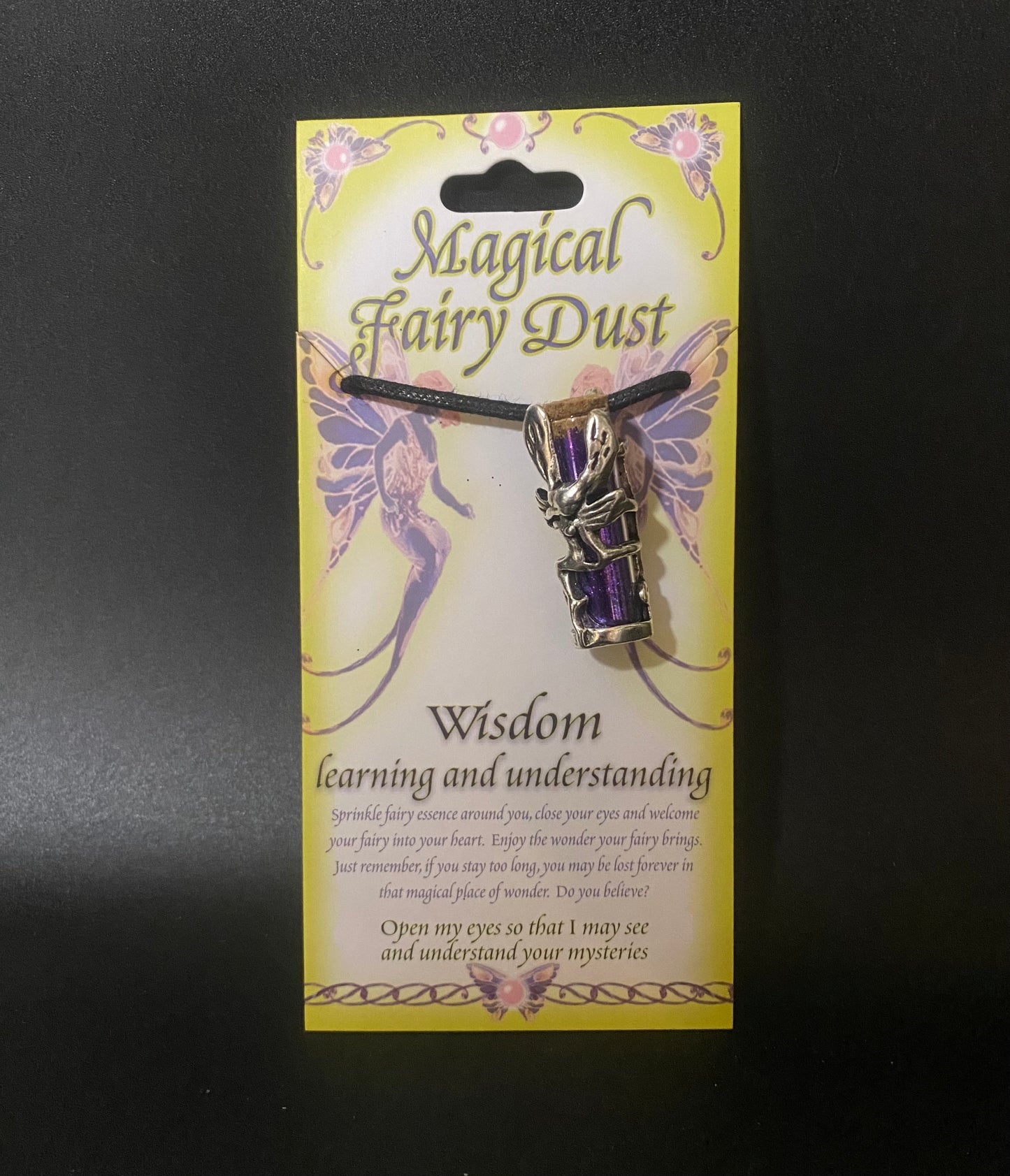 Fairy dust charm on a decorative card with text