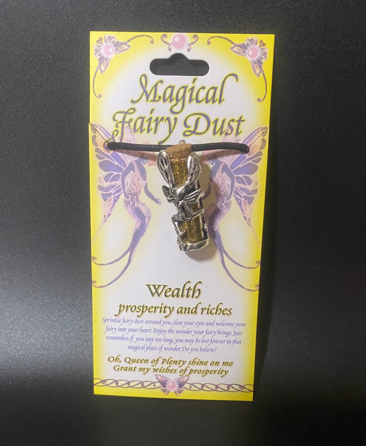Magical Fairy Dust necklace packaging with yellow background and fairy design.
