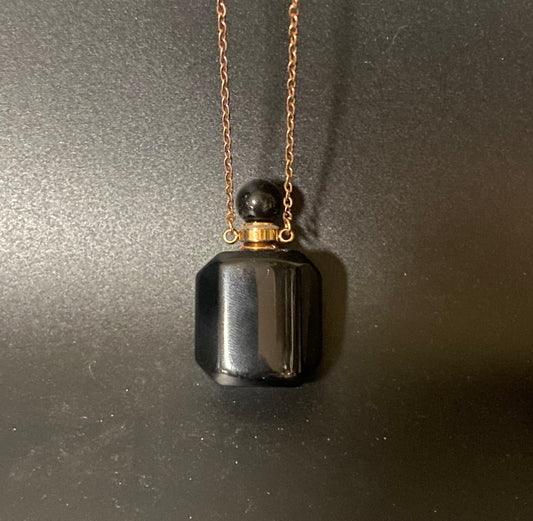 Black pendant necklace on a dark background
