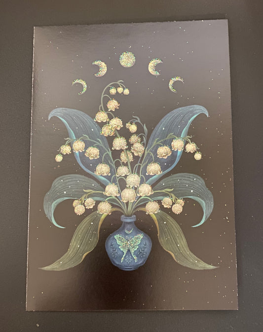 A square art print or card featuring a stylized bouquet of cream-colored flowers in a blue vase, with pale blue leaves and gold crescent moons against a dark brown speckled background.
