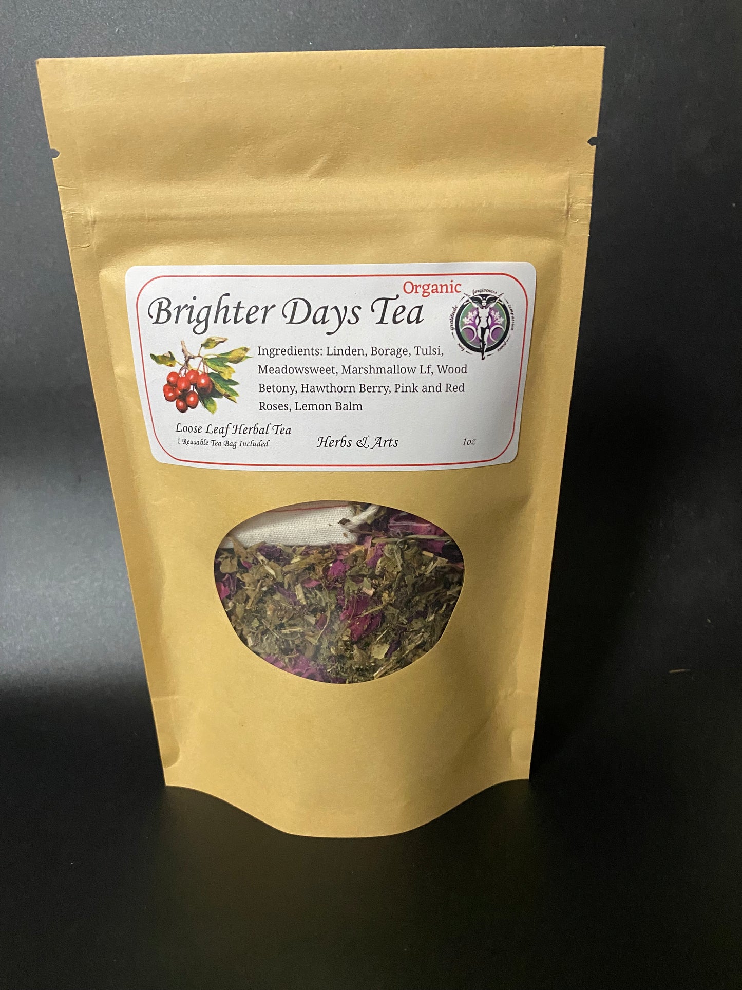 A stand-up kraft paper pouch of Brighter Days Tea with a white label and a circular window showing loose herbal tea inside, photographed on a dark surface.