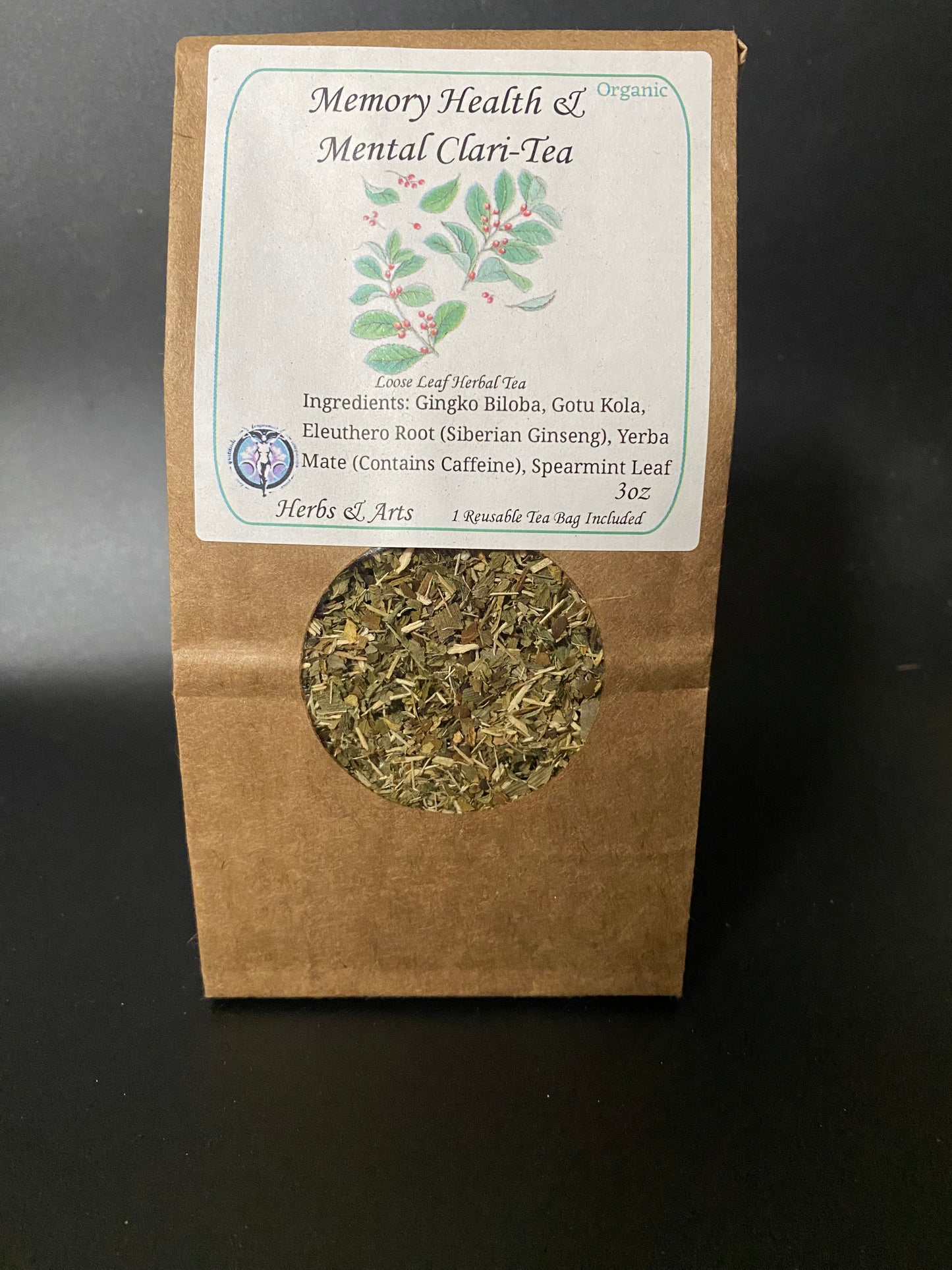 A stand-up kraft paper pouch of Memory Health & Mental Clari-Tea with a white label and a circular window showing loose leaf herbal tea inside, photographed against a dark background.