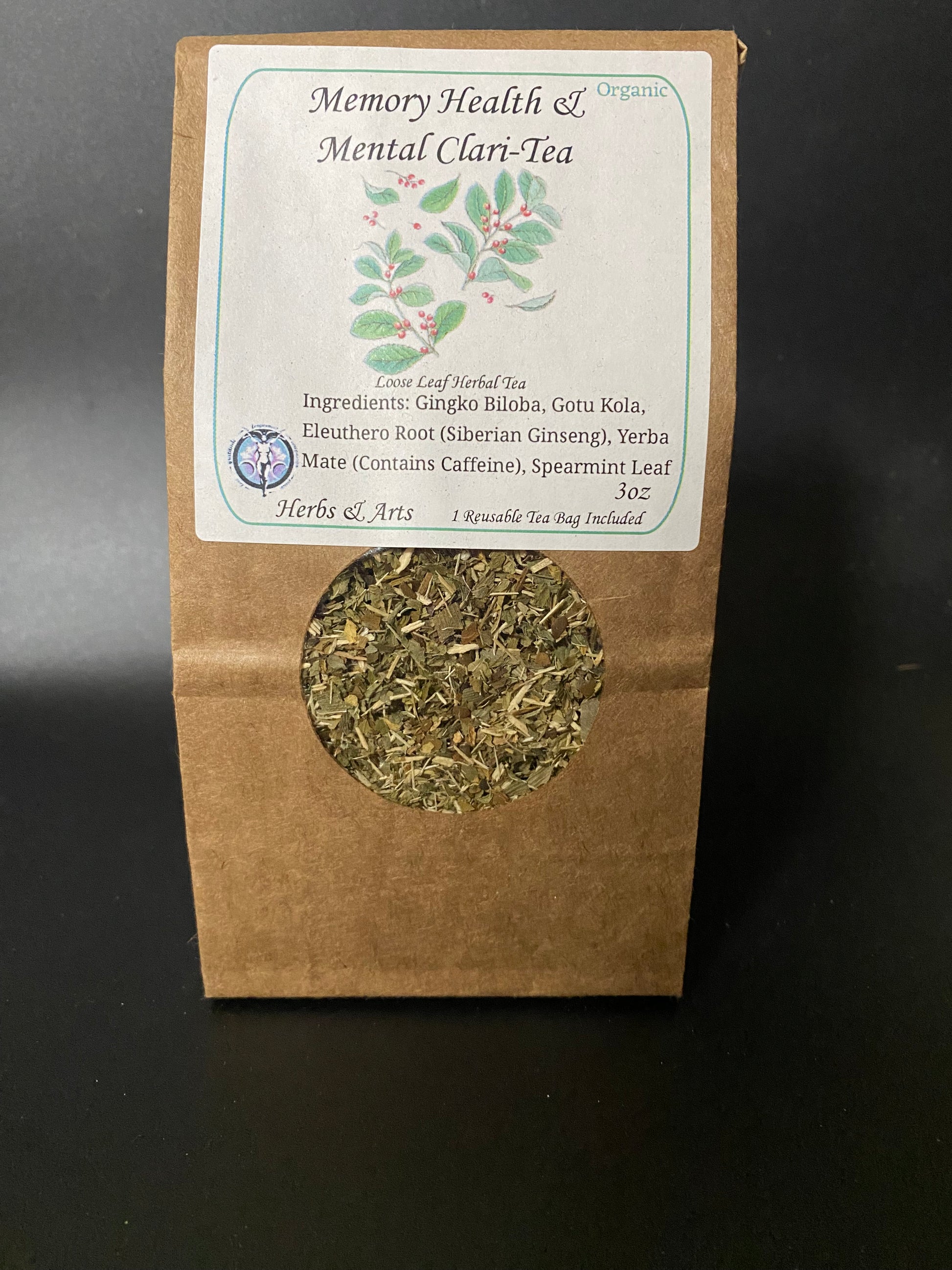 A stand-up kraft paper pouch of Memory Health & Mental Clari-Tea with a white label and a circular window showing loose leaf herbal tea inside, photographed against a dark background.