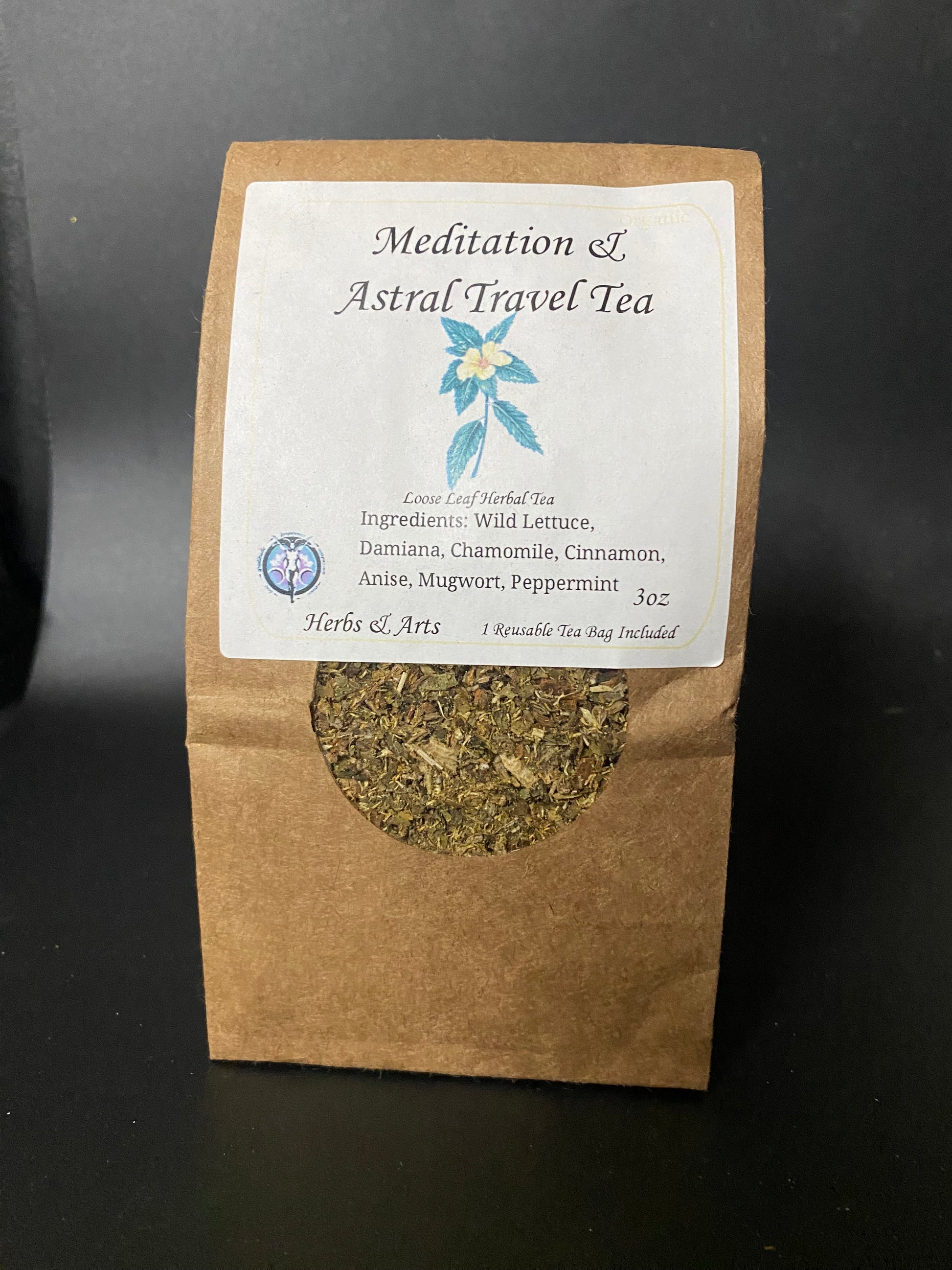 A stand-up kraft paper pouch of Meditation & Astral travel Tea with a white label and a circular window showing the dried herbal tea inside, photographed against a dark background.