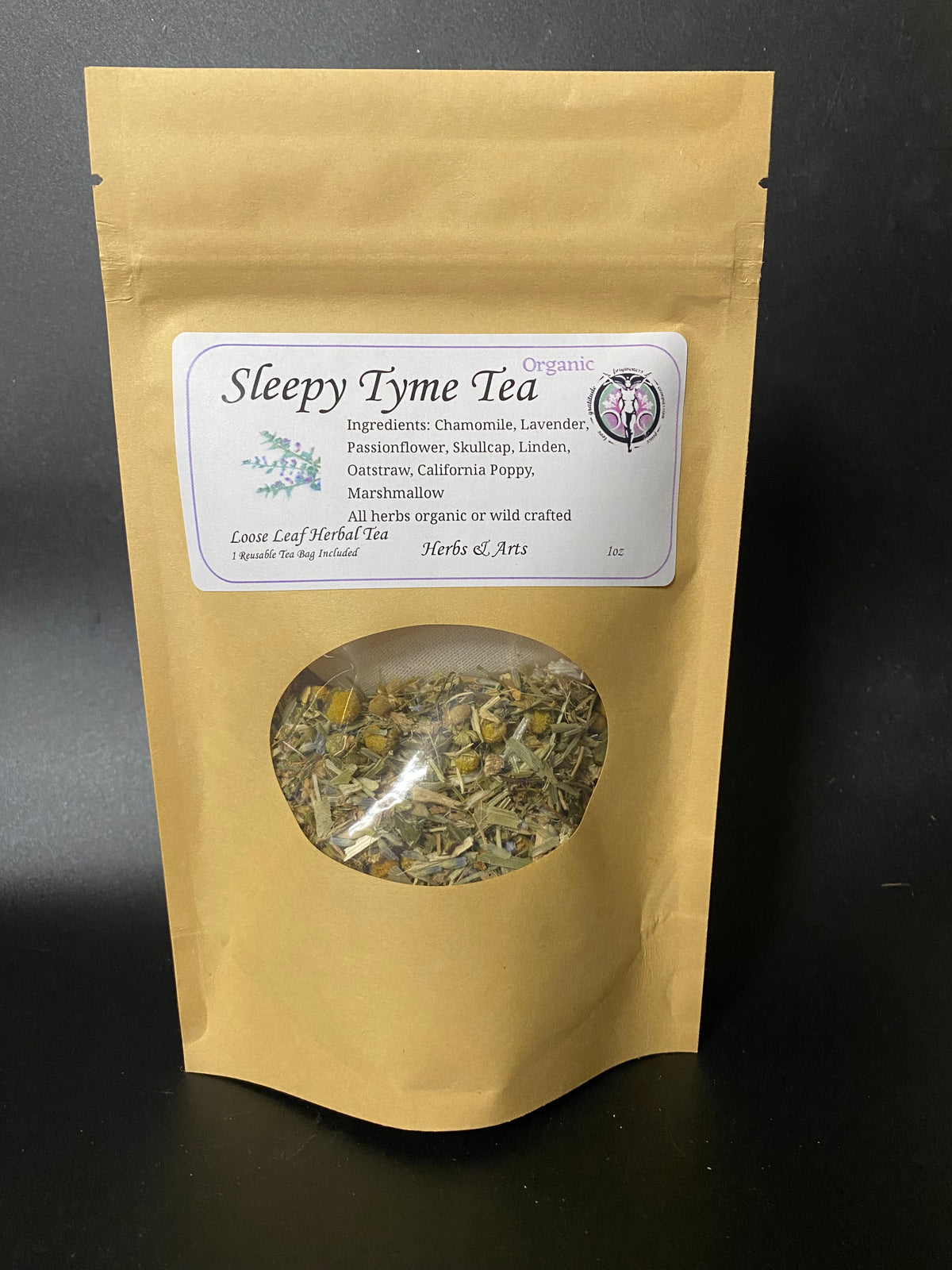 A stand-up kraft paper pouch of Sleepy tyme Tea with a white label and a circular window showing loose leaf herbal tea inside, photographed against a dark background.