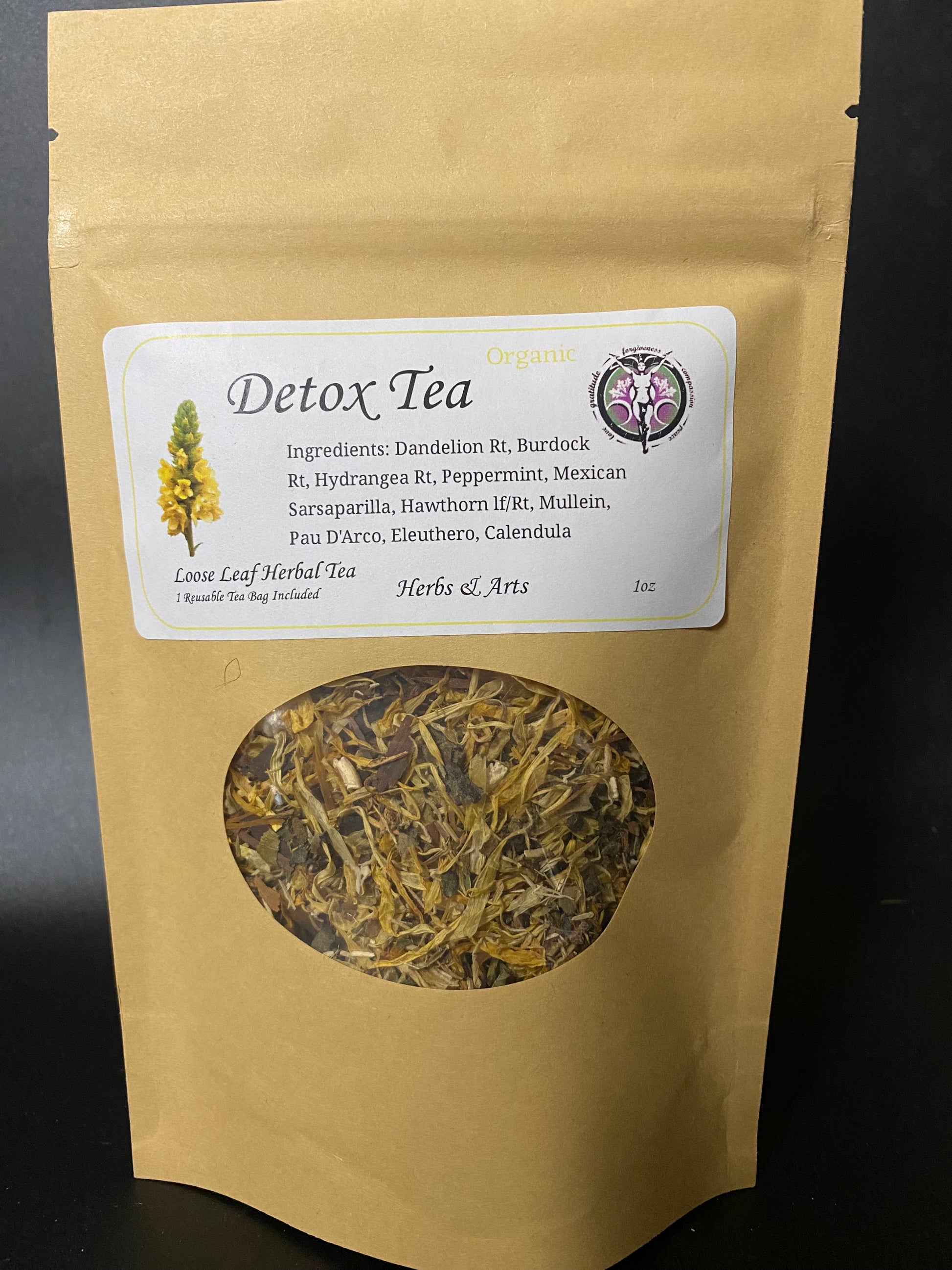 A stand-up kraft paper pouch of Detox Tea with a white label and a circular window showing the dried herbal tea inside, photographed against a dark background.