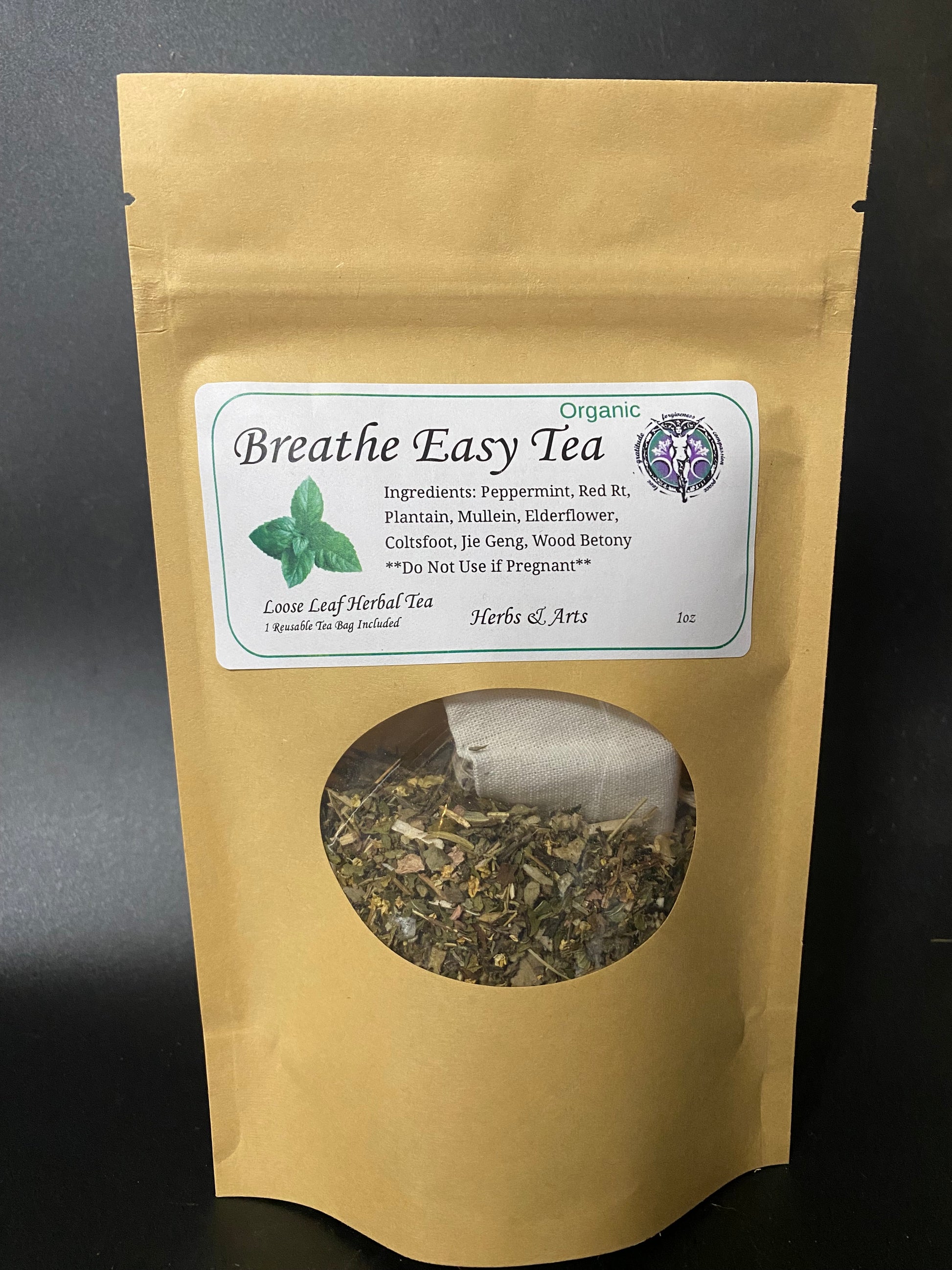 A kraft paper stand-up pouch of Breathe Easy Tea with a white label and a circular window showing loose herbal tea inside, photographed against a dark background.