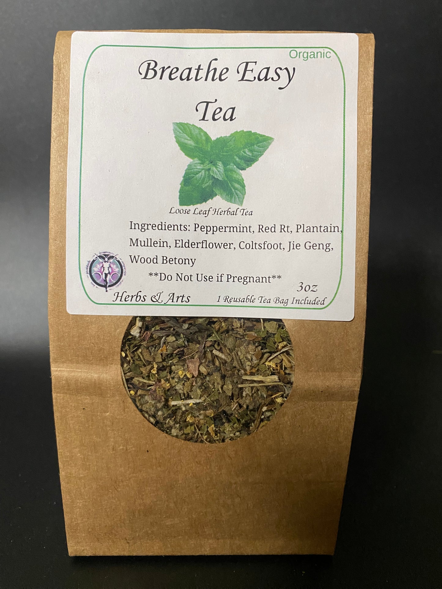 A 3 oz paper bag of Breathe Easy Organic Loose Leaf Herbal Tea by Herbs & Arts, featuring a kraft brown bag with a white label and a circular window showing the dried herbal blend inside.