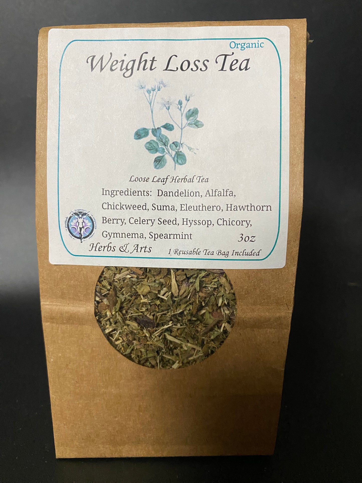 A 3 oz bag of Organic Weight Loss Tea by Herbs & Arts, in a brown kraft paper pouch with a clear window showing the loose leaf tea inside. The white label features blue-green botanical illustrations and lists ingredients like dandelion, alfalfa, and spearmint.