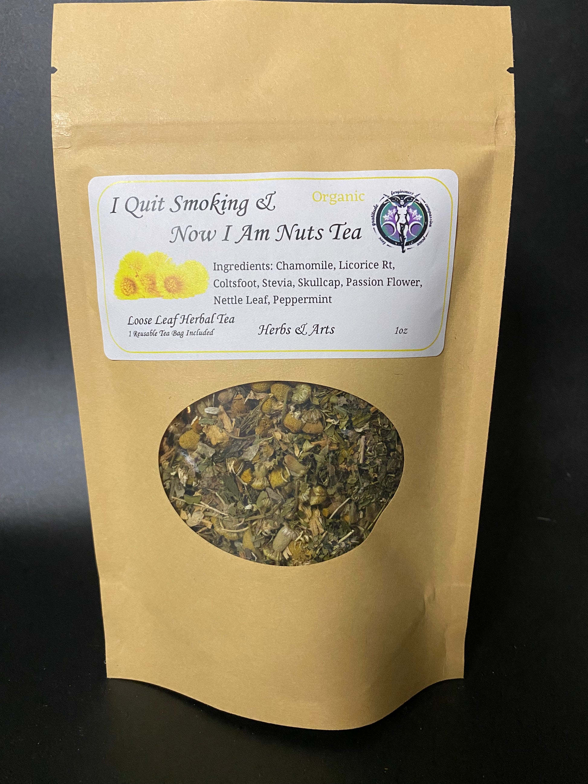 A kraft paper stand-up pouch of herbal tea with a white label reading 'I Quit Smoking & Now I Am Nuts Tea' and a circular window showing the loose herbal blend inside, photographed against a dark background.
