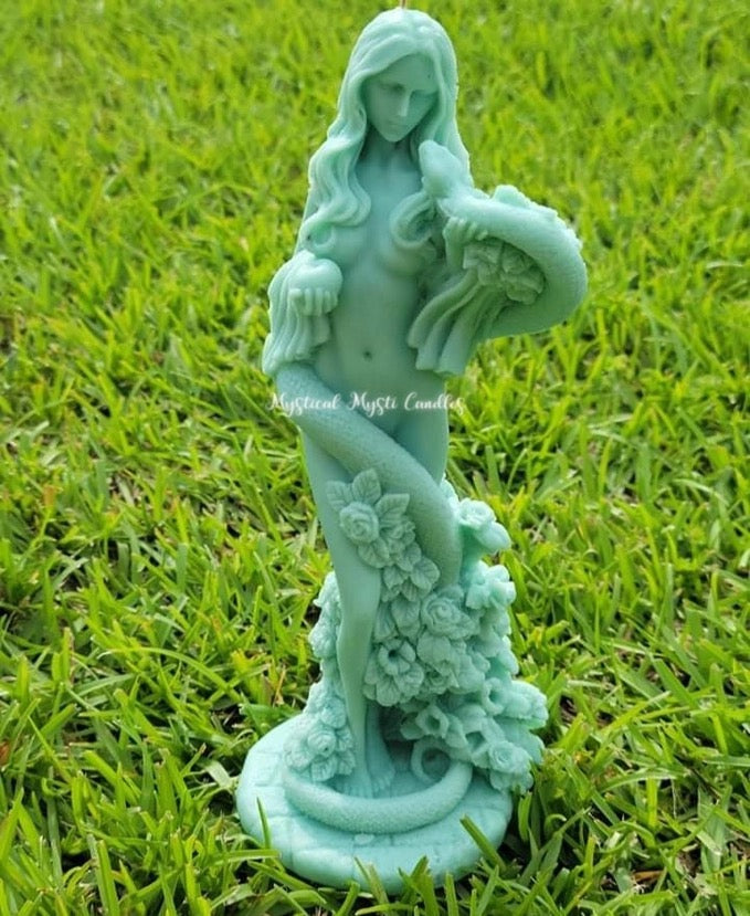 Turquoise garden statue of a woman with flowers on grass