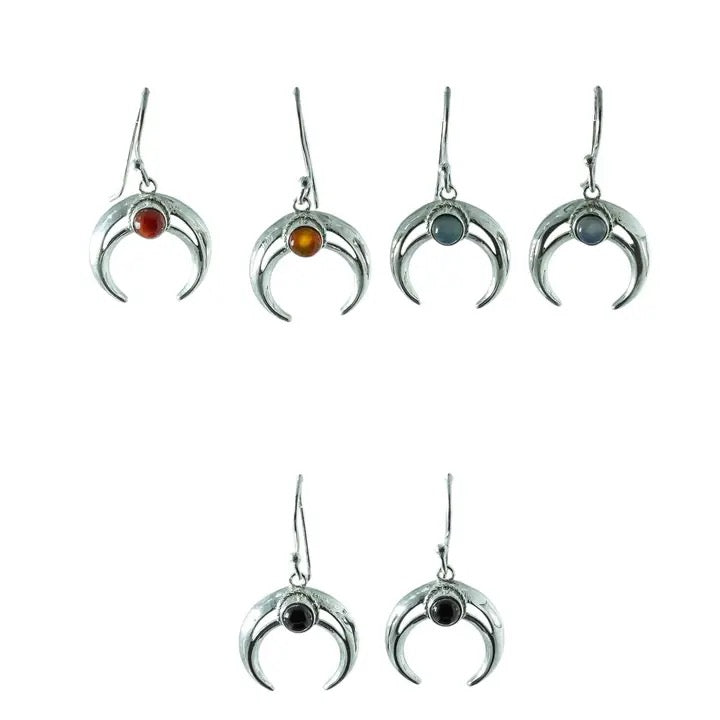 Set of silver earrings with colored gemstones on a white background
