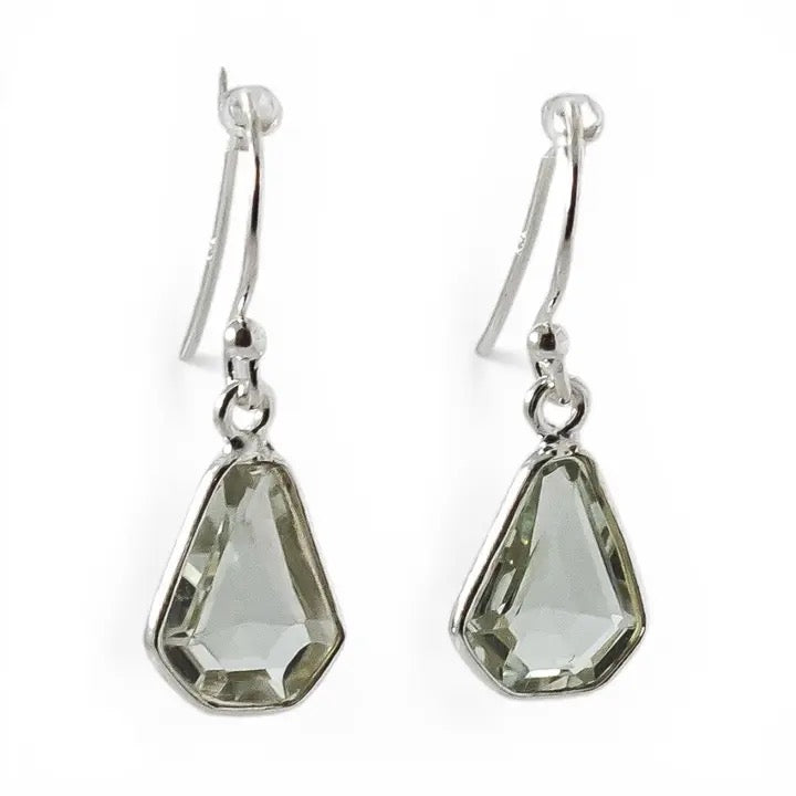 Pair of silver earrings with green teardrop-shaped gemstones on a white background