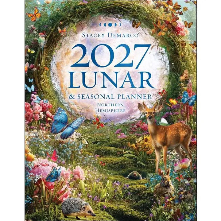 Front cover of the 2027 Lunar & Seasonal Planner by Stacey Demarco, featuring a whimsical illustrated garden scene with a deer, hedgehog, flowers, butterflies, and a large central moon circle with the title text.