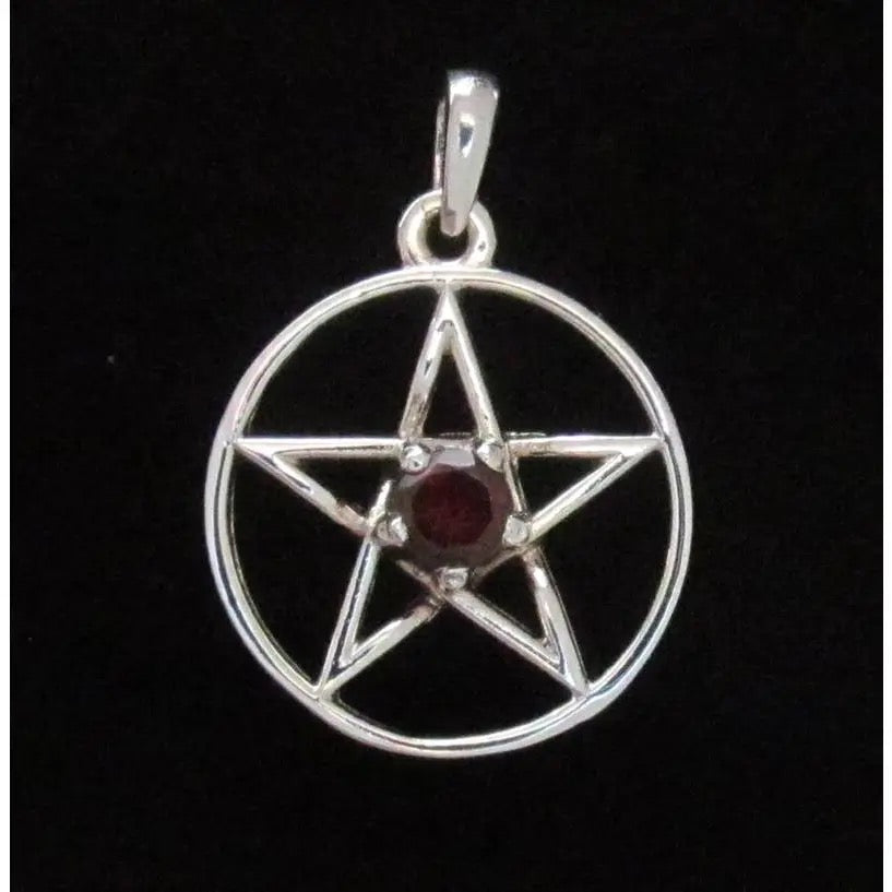 Silver pentacle pendant with a red gemstone on a black background