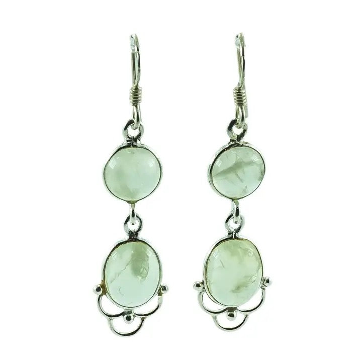 Pair of earrings with green gemstones on a white background